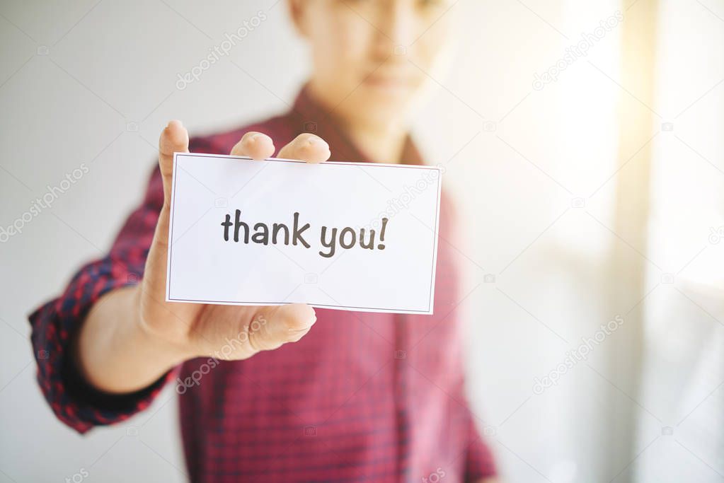 man showing card with text thank you 