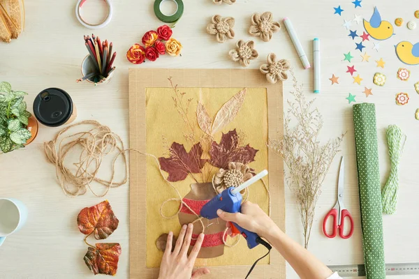 Çiçek resim dekorasyon süre sıcak tutkal tabancası kullanan kadın görünümünü hemen üstüne 