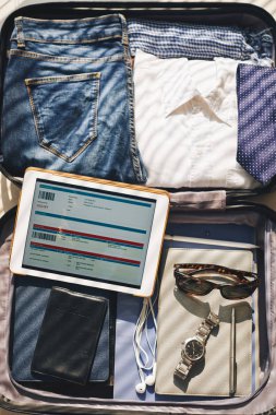 Giysi, belgeler ve elektronik bilet tablet ile Bagaj Close-up