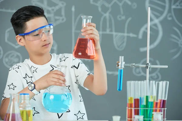 Concentrated Asian Boy Wearing Protective Goggles Holding Flasks Liquids — Stock Photo, Image