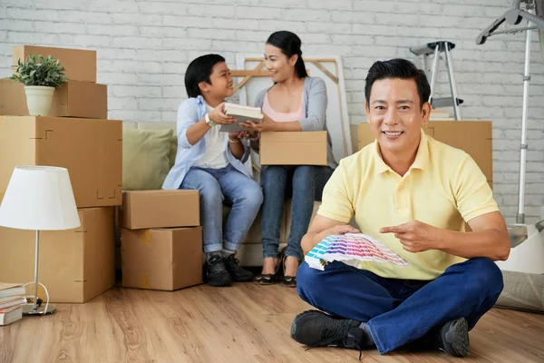 Asian Man Sitting Lotus Position Floor Pointing Color Swatch While — Stock Photo, Image