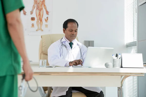 Indian Male Doctor Sitting His Workplace Typing Laptop — Stock Photo, Image