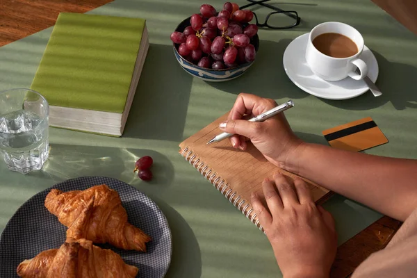 Unrecognizable Woman Sitting Kitchen Table Taking Necessary Notes Appetizing Croissants — Stock Photo, Image