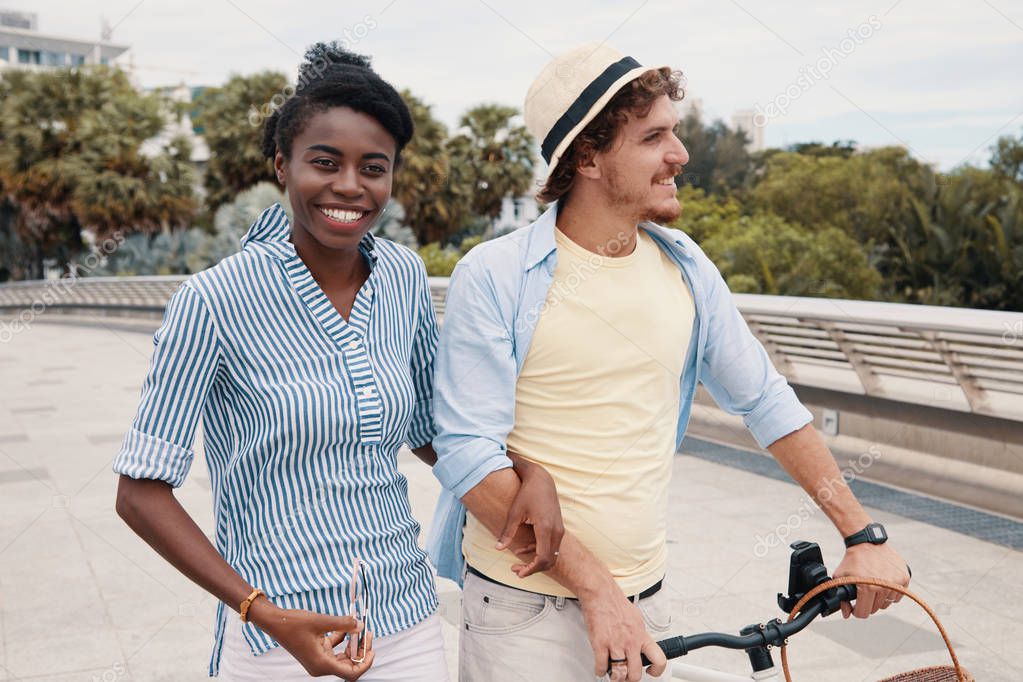 multiethnic couple in love with bicycle 