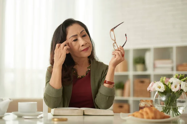 Reife Frau Sitzt Tisch Und Hat Kopfschmerzen — Stockfoto