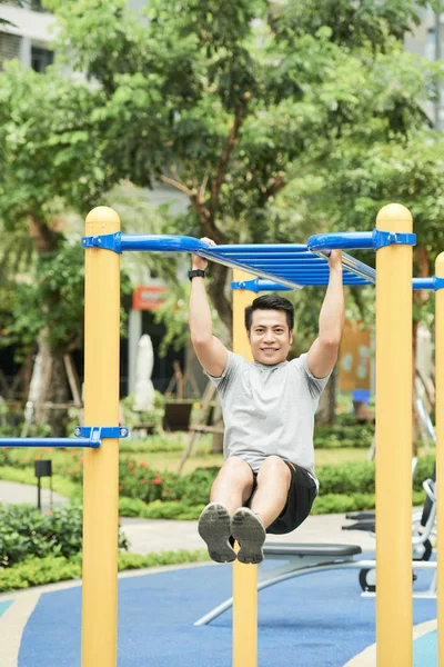 Cheerful Sporty Man Doing Pull Ups Outdoors — Stock Photo, Image