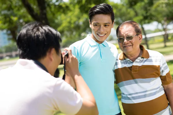 Smiling Teenage Boy Photographing His Grandfather — Stock Photo, Image