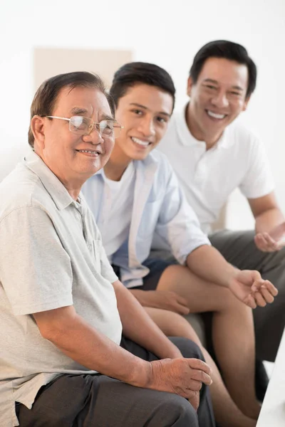 Cheerful Vietnamese Grandfather Father Son Sitting Sofa Looking Camera — Stock Photo, Image