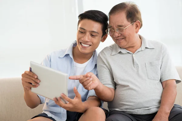 Cheerful Asian Teenager Boy His Grandfather Looking Tablet Screen — Stock Photo, Image