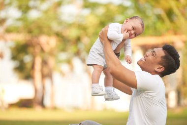 Açık havada onun bebek ile oynarken mutlu heyecanlı baba