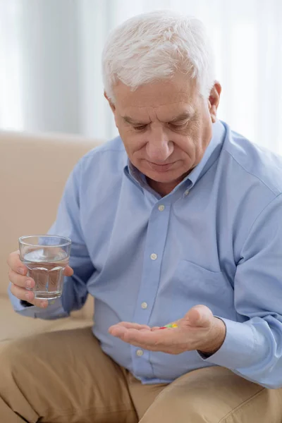 Senior Man Taking Handful Pills Sitting Sofa — Stock Photo, Image
