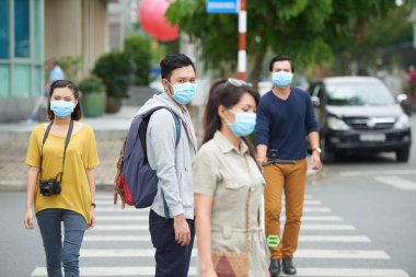 Asya kent sakinlerinin yüzü maskeli hava kirliliği nedeniyle açık havada yürüyüş