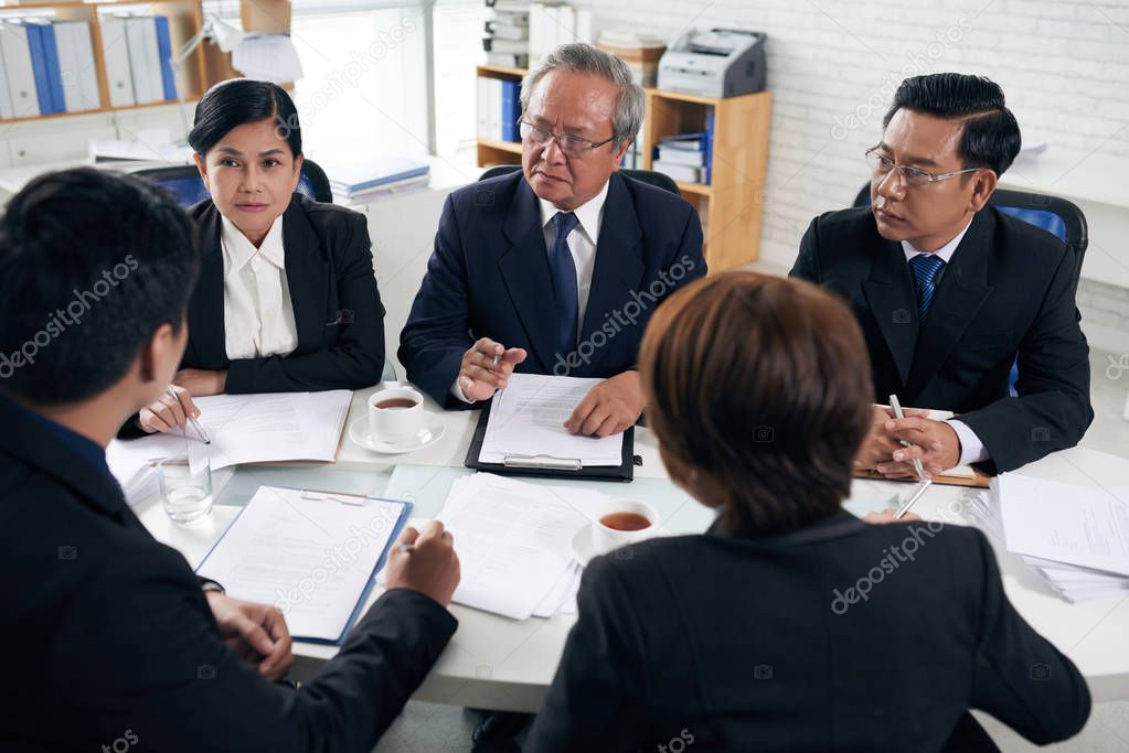 asian business partners having meeting at table in office 