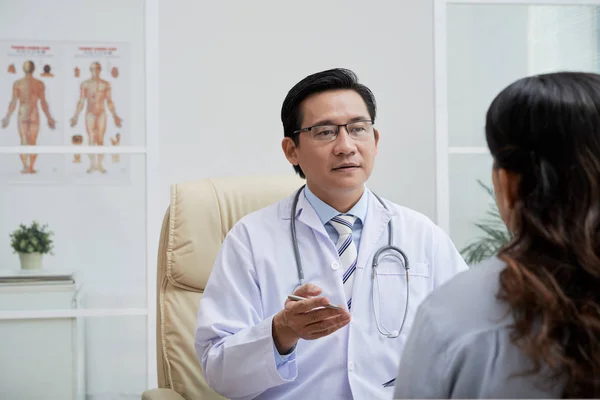 Experienced Asian Doctor Consulting Female Patient Office — Stock Photo, Image