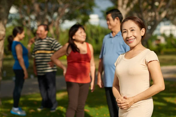 Cheerful Senior Vietnamese Woman Looking Camera While Friends Talking Background — Stock Photo, Image