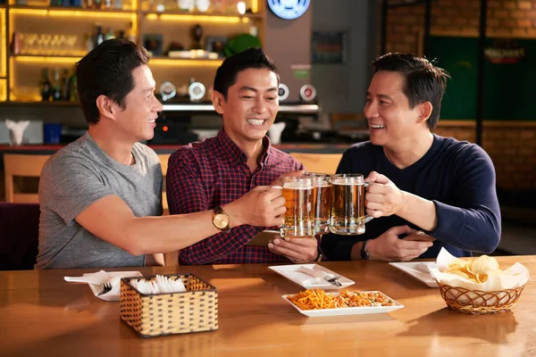 Group Happy Vietnamese Men Clinking Beer Mugs — Stock Photo, Image