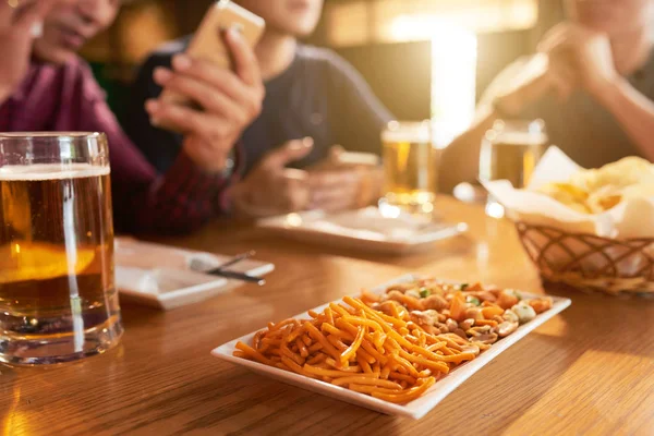 Plate Tasty Salty Snacks People Sitting Table Bar — Stock Photo, Image