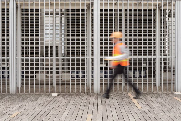 Construction worker hurrying to work, blurred motion