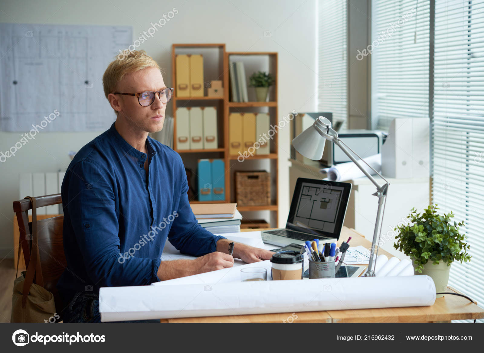 Toeval passage spleet Professional Young Architect Working Bureau Desk Blueprint Digital Tablet  Stock Photo by ©DragonImages 215962432