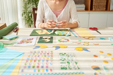 ahşap masada oturan ve sulak dekor sanat resim yapma Tasarımcı kadın 