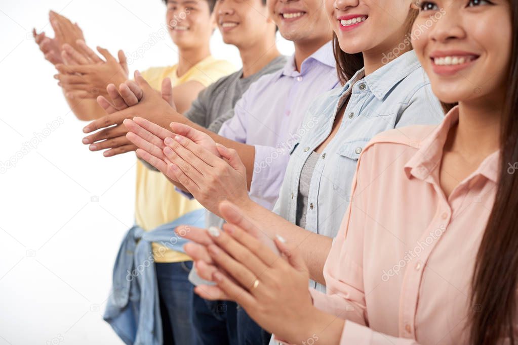 Cropped image of applauding smiling people