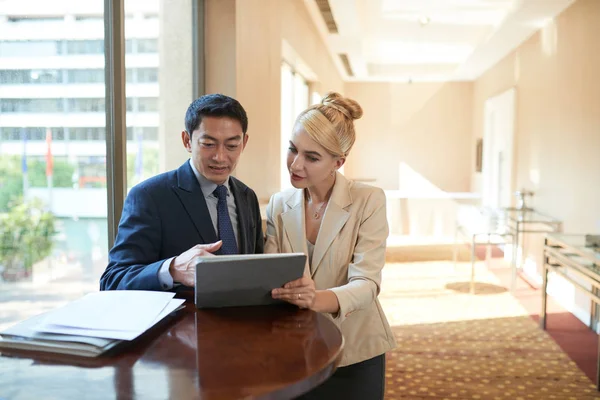 Business people analyzing information on tablet computer