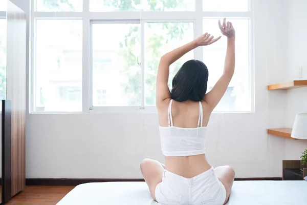 Back View Slim Woman Arms Raised Sitting Bed Daylight Stretching — Stock Photo, Image