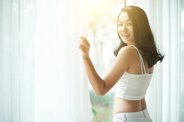 Happy Bright Asian Woman White Top Standing Window White Curtains — Stock Photo, Image