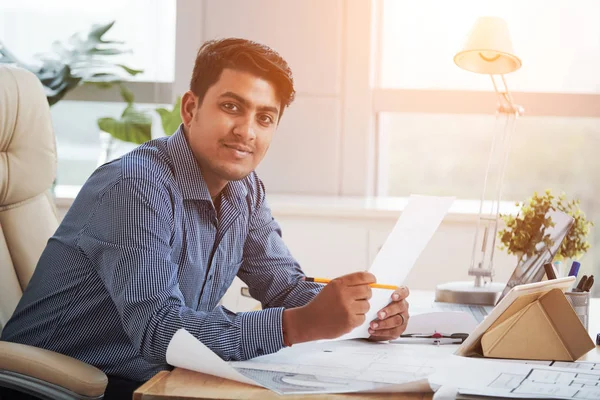 Side View Cheerful Indian Man Holding Papers Office Looking Camera — Stock Photo, Image