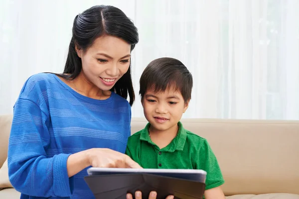 Mother Showing Cartoon Tablet Computer Her Son — Stock Photo, Image