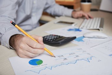 Close-up image of financial manager analyzing data in financial report clipart