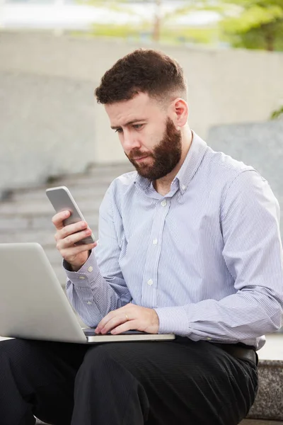 Handsome Bearded Businessman Sitting Outdoors Laptop His Laps Reading Text — Stock Photo, Image