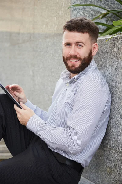 Portrait Handsome Cheerful Businessman Leaning Stone Wall Working Digital Tablet — Stock Photo, Image