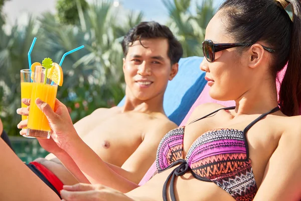 Joven Pareja Asiática Tintineando Vasos Jugo Cuando Descansa Piscina —  Fotos de Stock