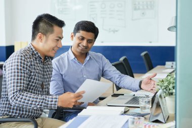 Onun fikirleri için Hint iş arkadaşınız gösterilen Vietnamca Ux designer