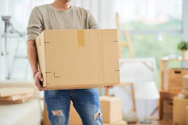 man carrying large cardboard box on moving day