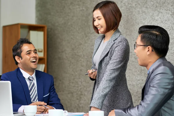 Smiling Young Female Leader Listening Her Colleagues Laughing Together Table — Stock Photo, Image
