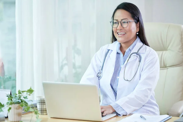 Neşeli Yetişkin Asyalı Kadın Doktor Beyaz Uzağa Konuşurken Gülümseyen Dizüstü — Stok fotoğraf