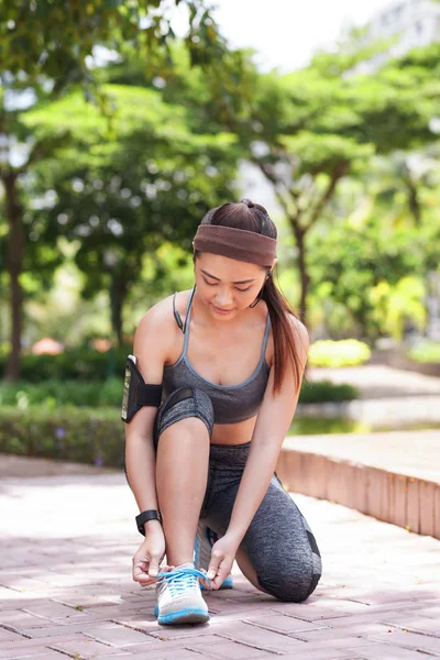 Young Slim Woman Sportswear Armband Tying Shoelace Paved Walkway Summer — Stock Photo, Image
