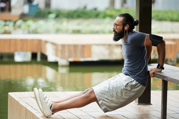 Side View Bearded Indian Man Doing Warming Exercise Outdoors Listening — 图库照片