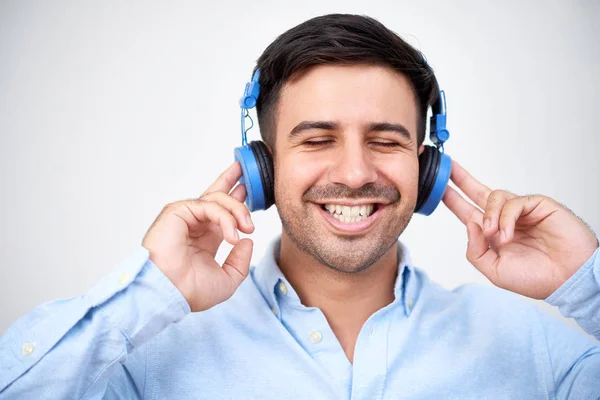 Portrait Young Happy Man Wearing Headphones Listening Music White Background — Stockfoto