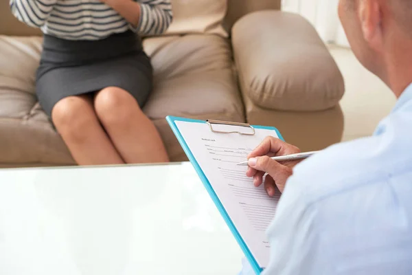 Close Male Psychotherapist Holding Clipboard Filling Information Patient — Stock Photo, Image