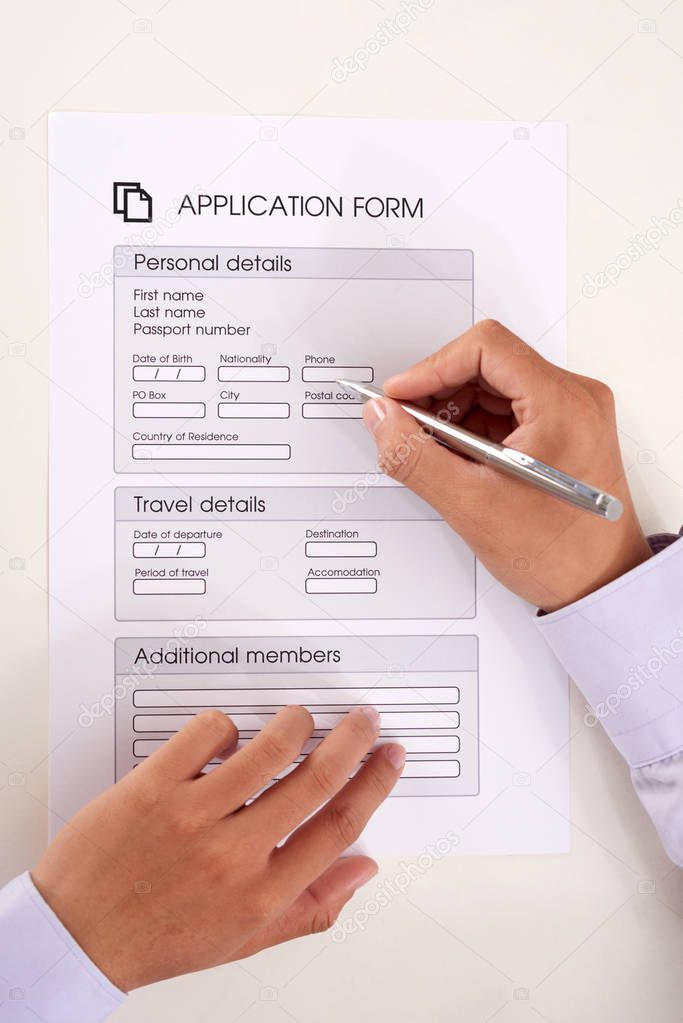 Hands of businessman filling application form for getting visa