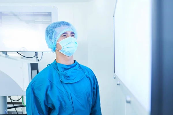 Young Asian Man Mask Uniform Looking Screen Monitor While Standing — Stock Photo, Image