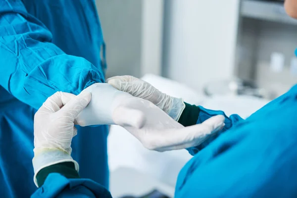 Asistente Quirúrgico Irreconocible Ayudando Cirujano Ponerse Guantes Látex —  Fotos de Stock