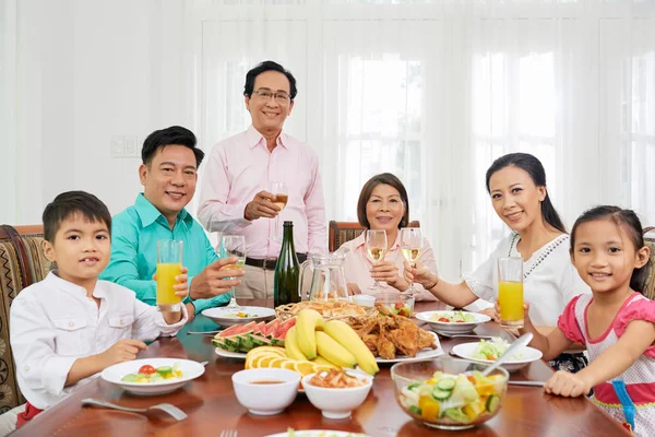 Cheerful happy big Vietnamese family celebrating holiday at home