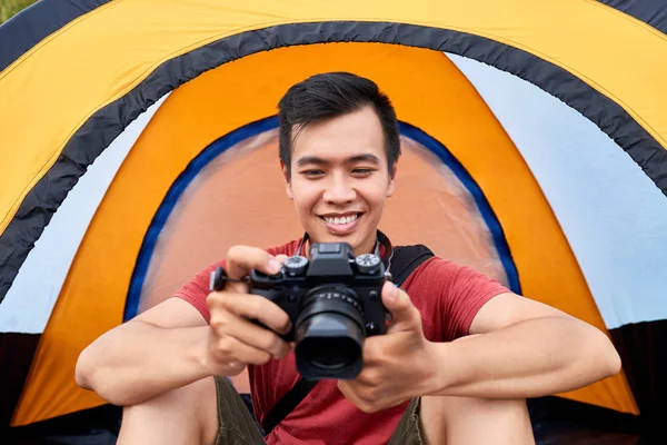 陽気なベトナム旅行者彼のテントに座っていると デジタル カメラの写真を確認 — ストック写真
