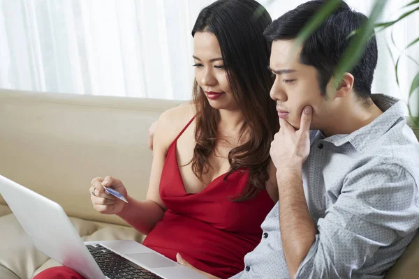 Young mixed-race couple choosing presents in online store