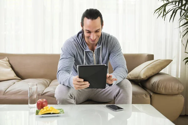 Smiling Young Man Watching Something Tablet While Sitting Front Table — Stock Photo, Image