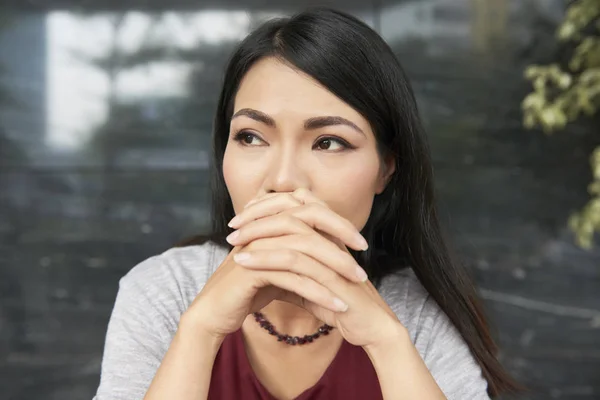 Asian Young Brunette Sitting Outdoors Looking Away Thinking Something — Stock Photo, Image